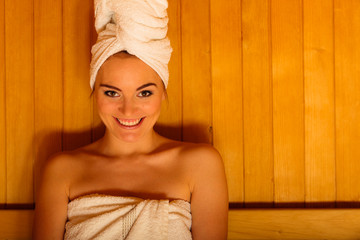 Woman white towel in sauna room