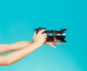 Photographer hands holding camera shooting images