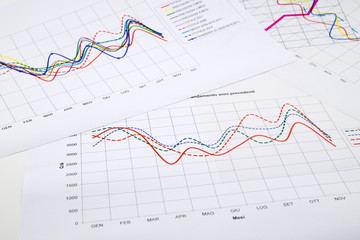 stack of paper documents with financial reports and statistic in