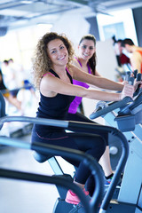 Group of people running on treadmills