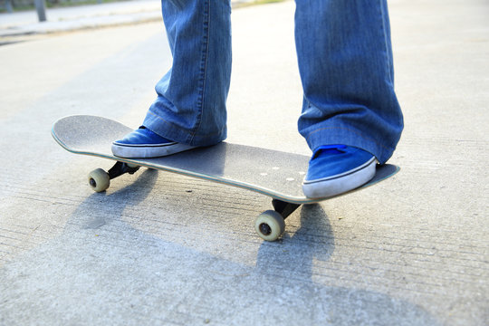 	skateboarder legs skateboarding at skatepark 