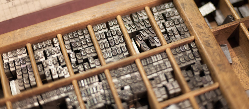 Close-up of metal letterpress letters in printing machine