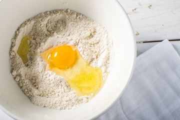 Flour and eggs in a bowl baking ingredients