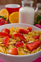 Healthy breakfast cornflakes with milk and fruits