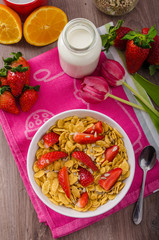 Healthy breakfast cornflakes with milk and fruits