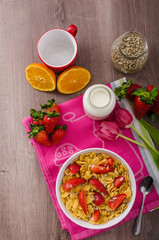 Healthy breakfast cornflakes with milk and fruits