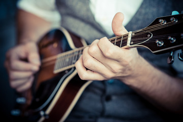 close up hands hipster man playing mandolin - obrazy, fototapety, plakaty