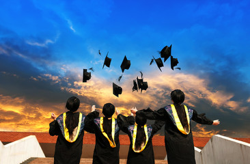 graduates throwing graduation hats in the air.