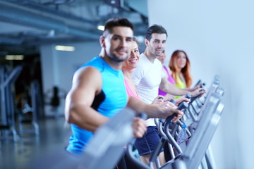 Fototapeta na wymiar Group of people running on treadmills