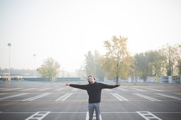 young crazy funny asian man in town outdoor lifestyle listening