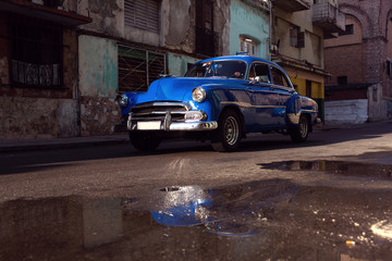 HAVANA - FEBRUARY 17: Classic car and antique buildings on Febru
