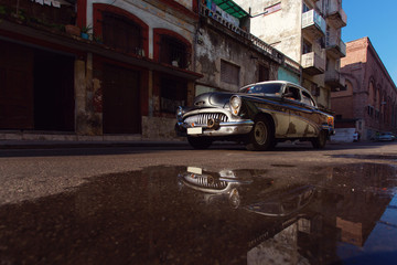 HAVANA - FEBRUARY 17: Classic car and antique buildings on Febru