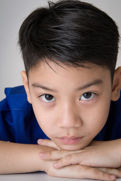 portrait of asian cute boy sad and  looking very disappointed