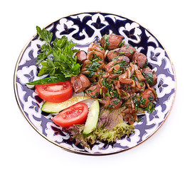 Fried meat with onion in a frying pan