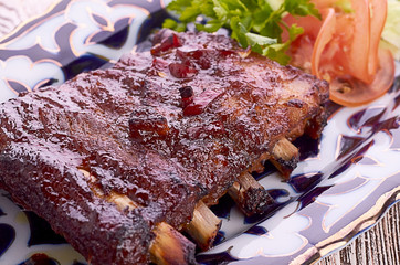 Meat on a grill with vegetables