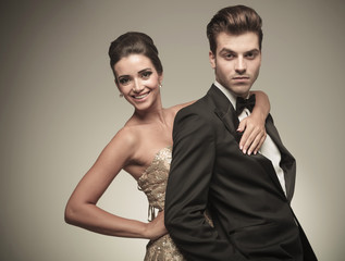 elegant woman embracing her husband from the back.