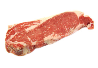 Single uncooked raw entrecote steak on a white background