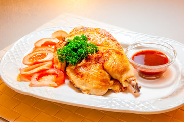 fried chicken beautifully served on a platter with sauce