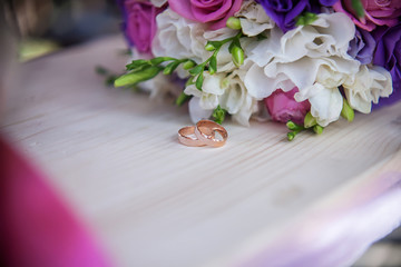 wedding rings and bouquet on the table