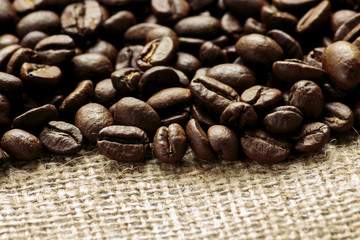 Arabica coffee beans on burlap background
