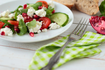 Plate with healthy salad with lettuce, tomato and cheese