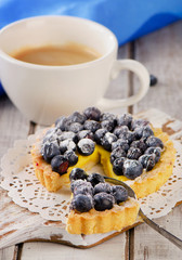 Berry tart and  cup of coffee