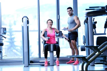 Tuinposter woman exercising with her personal trainer © .shock