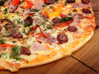 Tasty Italian pizza on wooden background