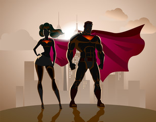 Superhero Couple: Male and female superheroes, posing in front o - obrazy, fototapety, plakaty