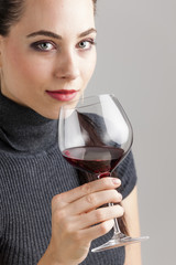 portrait of young woman with a glass of red wine