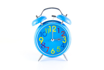 Alarm Clock isolated on white, in blue, showing three o'clock.