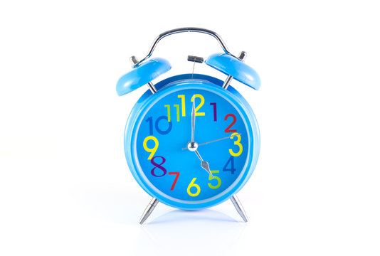 Alarm Clock isolated on white, in blue, showing five o'clock.