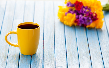 Cup of coffee and bouquet of flowers