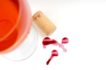 Wine glass and cork on white background