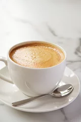 Foto auf Alu-Dibond Cappucino or latte milk coffee in white cup and saucer in a cafe © Jodie Johnson