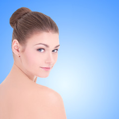 portrait of young beautiful woman with perfect skin over blue