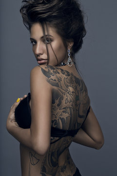 Sensual brunette woman with tattoo