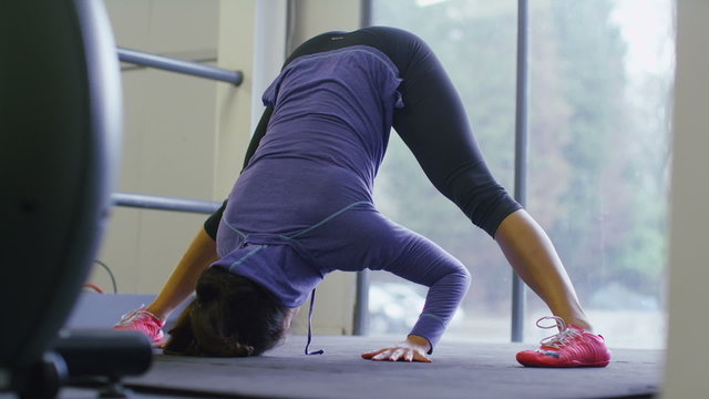 Flexible young woman stretching her hamstrings