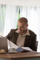 Fototapeta premium Businessman working with blueprints