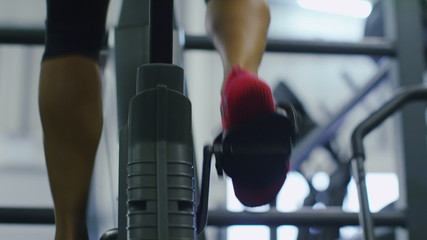 Close up of feet on an exercise bike in slow motion - Powered by Adobe