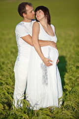 Happy parents are relaxing in grass