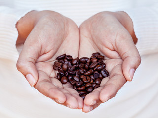 Hand of women holding coffee beans . - Concept for giving refres