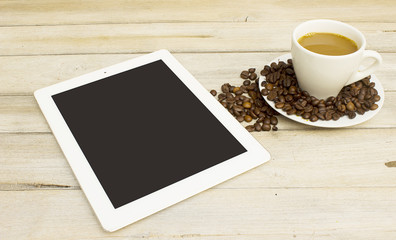 Fototapeta na wymiar Coffee and tablets on a wood table