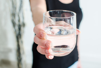 Woman showing a glass of water