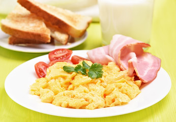 Breakfast scrambled eggs with bacon and tomatoes