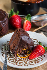 slice of homemade chocolate cake serving on retro plate