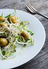 Obraz na płótnie Canvas Healthy sprouts and olives salad