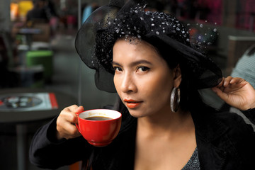 Asian woman with cup of coffee