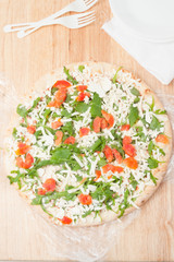 frozen pizza on wooden board