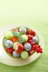 dragonfruit strawberry melon dessert on a green background